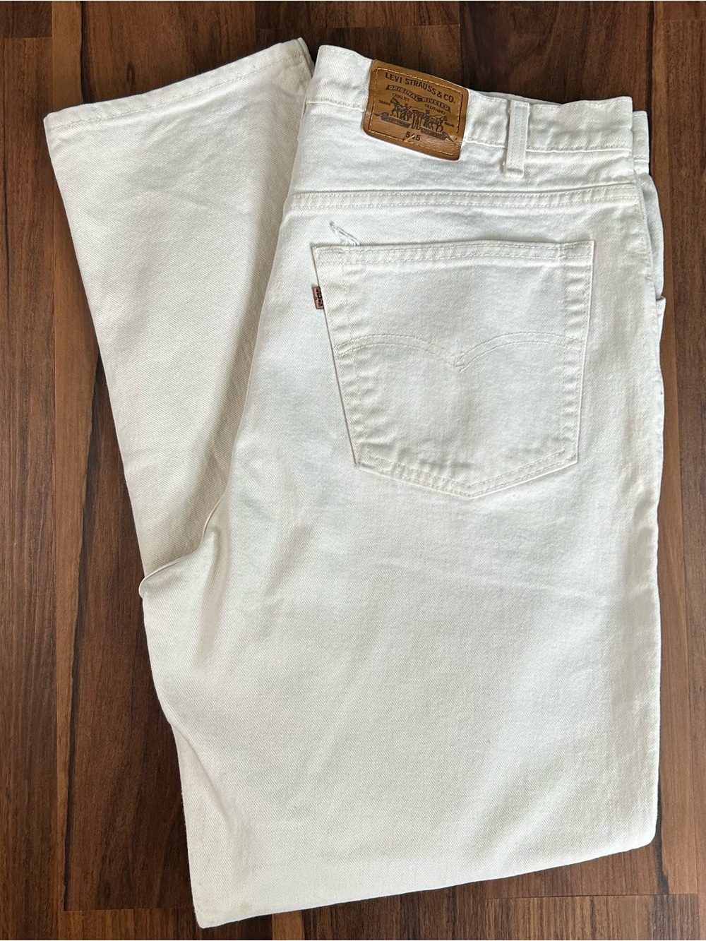 Vintage 1994 made in USA orange tab Levi 545s loose fit white jeans.